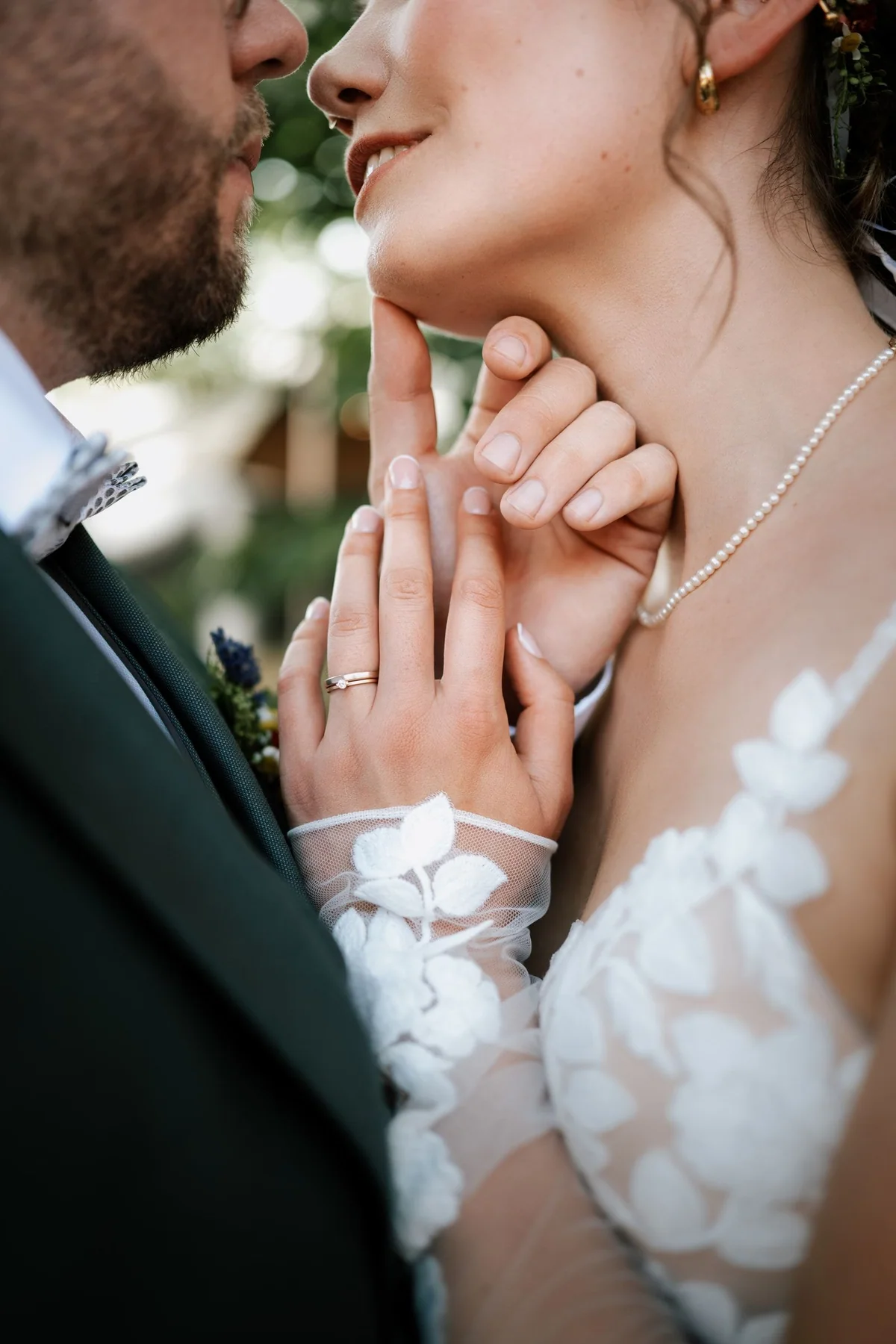 Close view of a wedding couple holding hands.