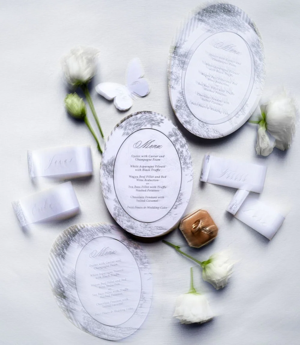 Wedding rings lie on a menu card.