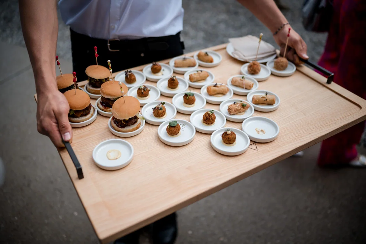 Small snacks and espresso cups on a tray.