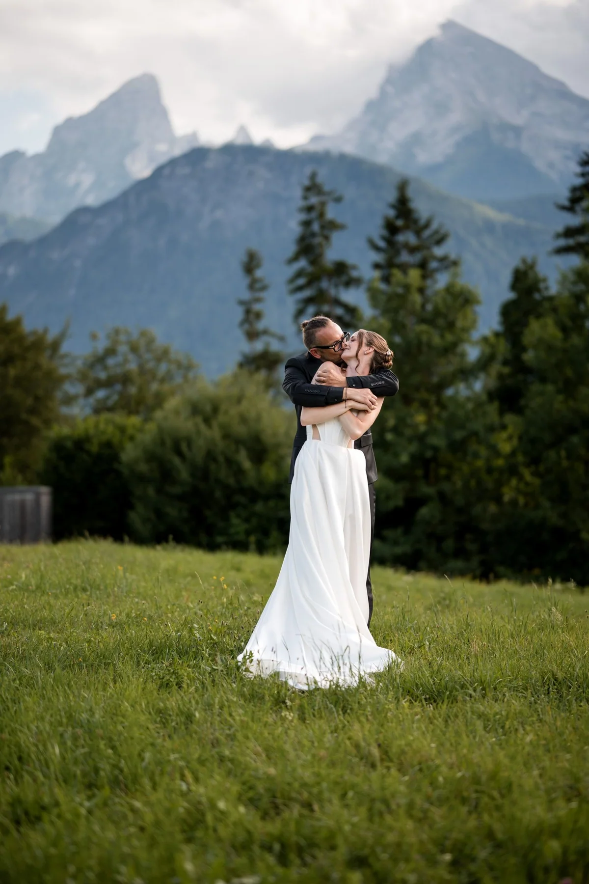 An embrace in front of the mountains.