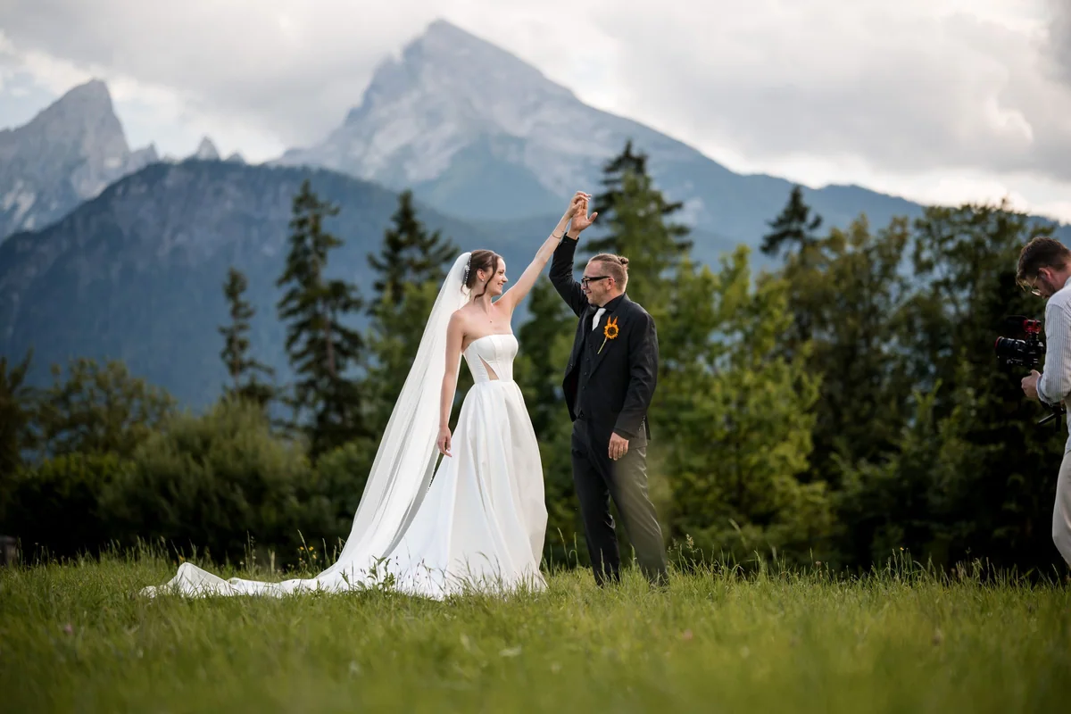 A hand in hand spin in front of the Alps.
