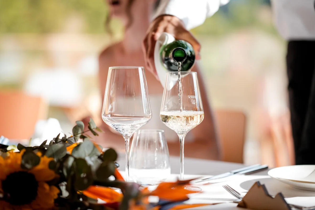 A drink is poured at the wedding table.