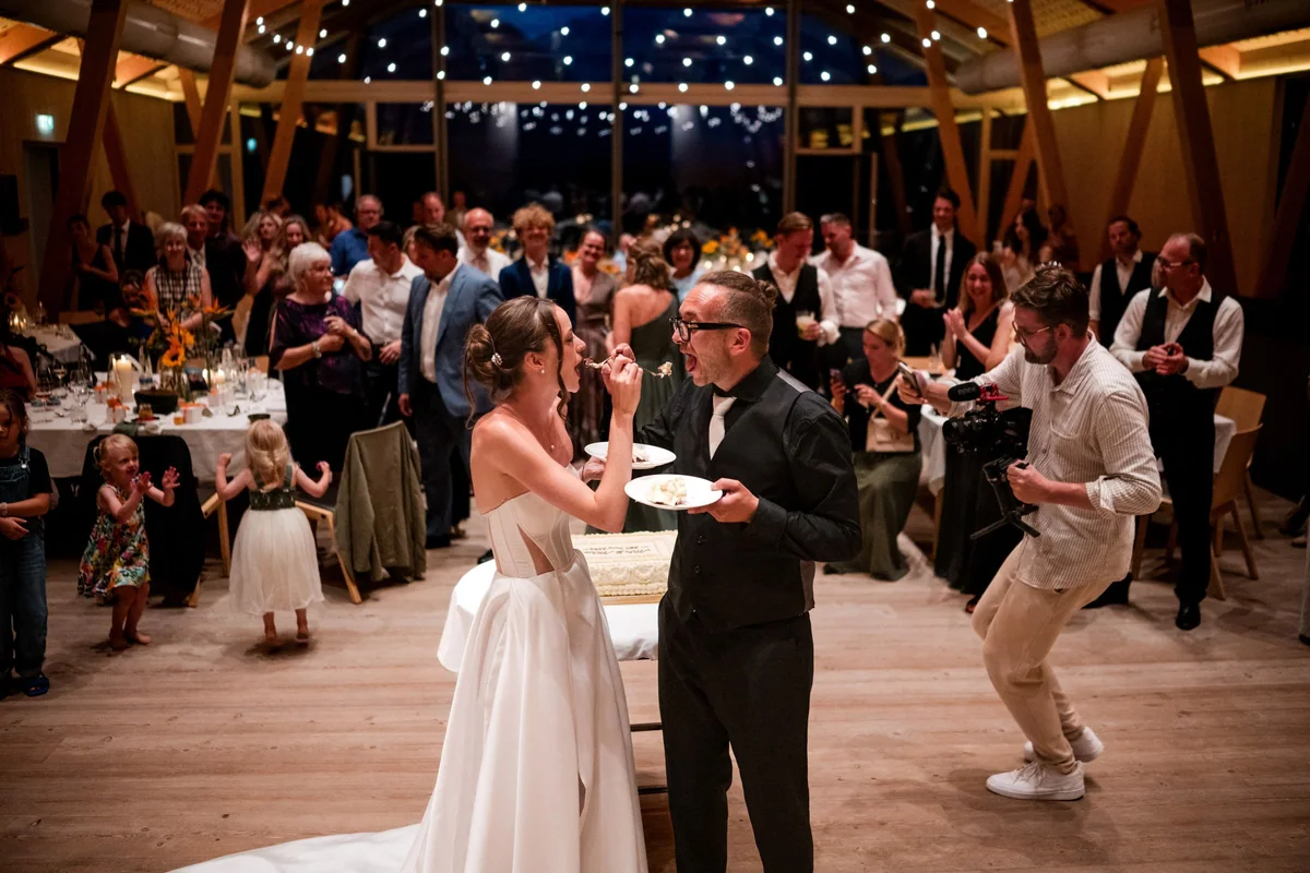 The couple cut the cake in front of their guests.