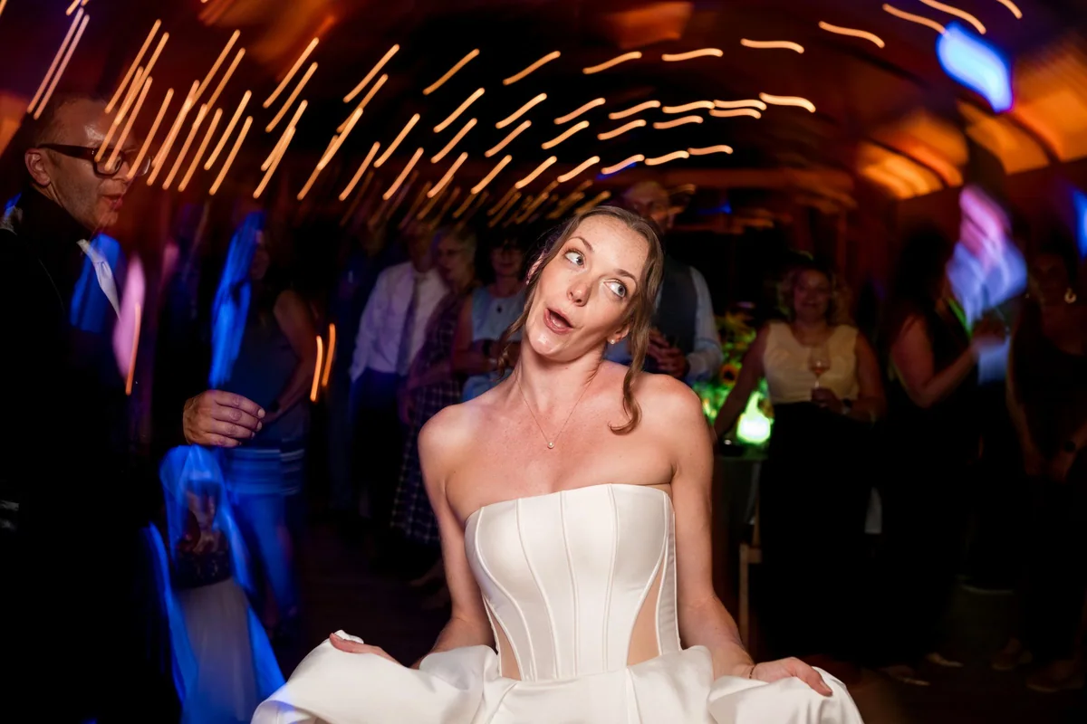 Brianna dances beneath colourful lights.