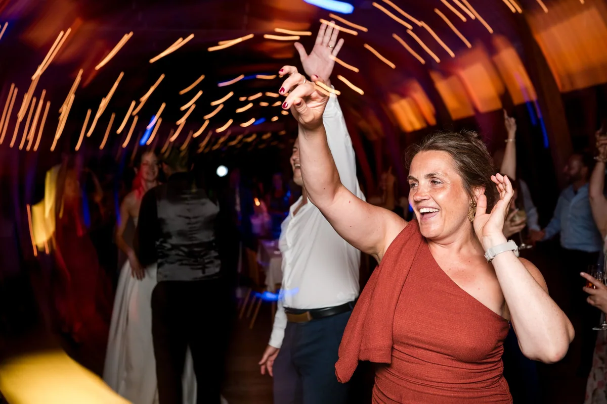 A guest dances with one arm raised.