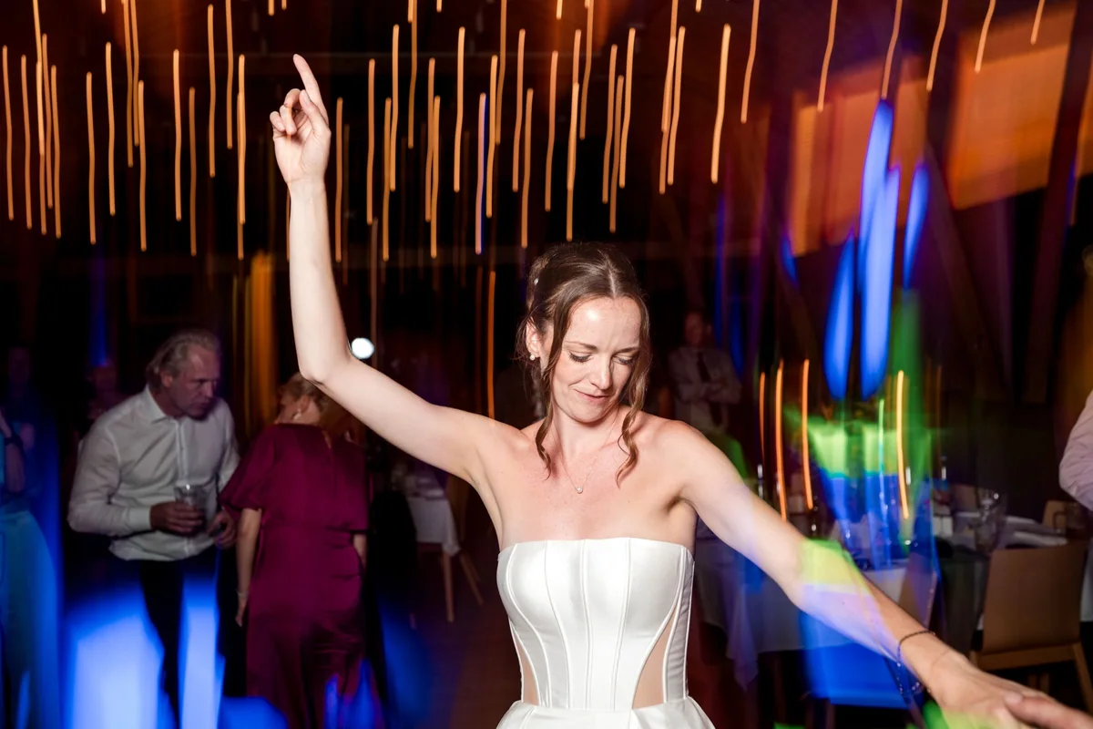 Brianna on the dance floor in colourful light.