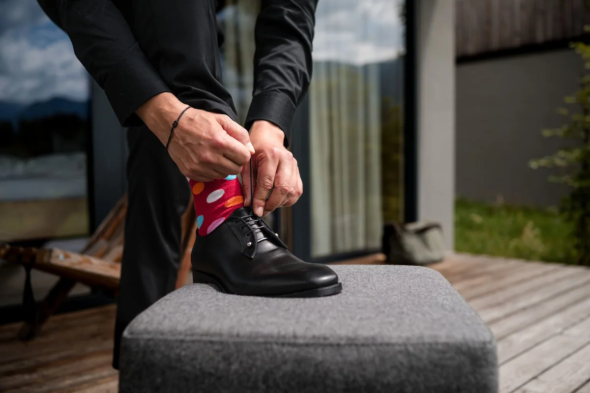 The groom ties his shoes.