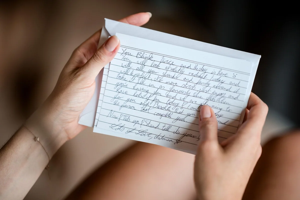 A personal letter held in someone’s hands.