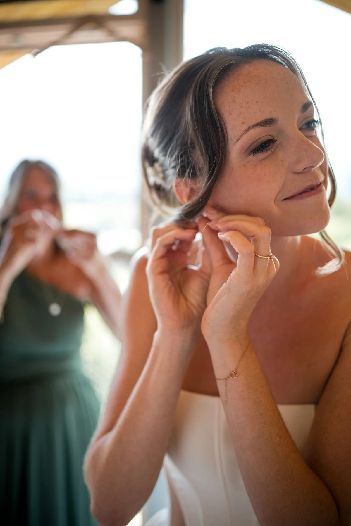 Brianna puts on her earring.