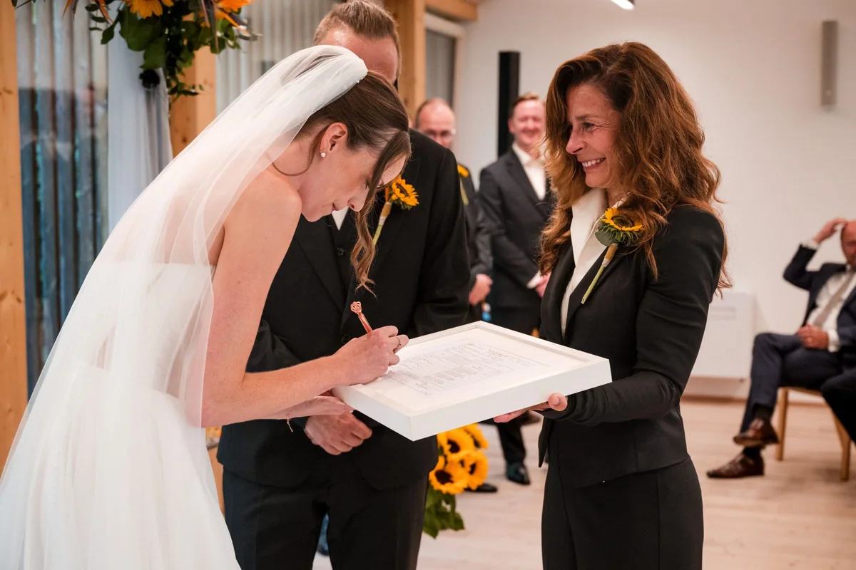 Brianna signs during the ceremony.